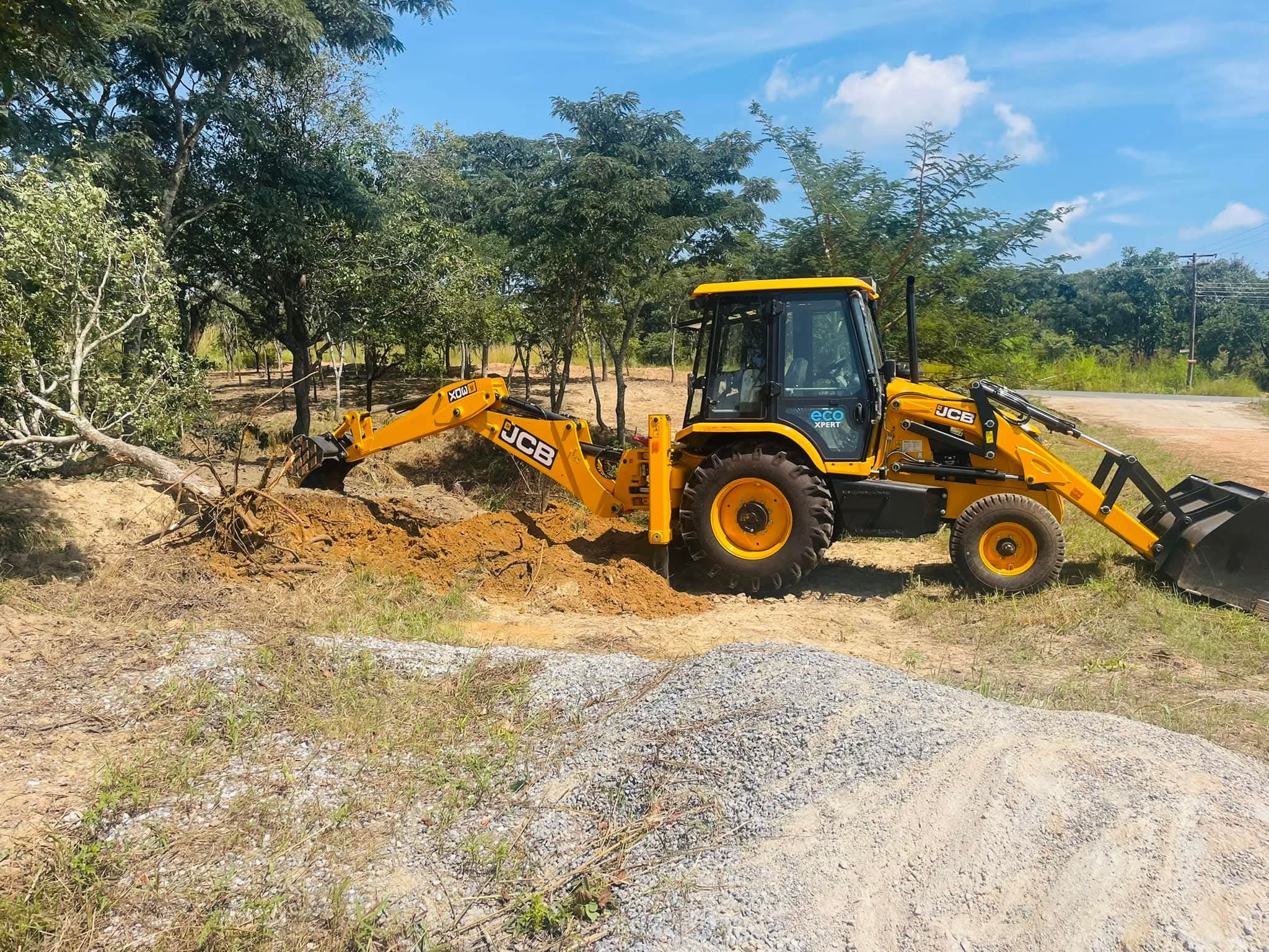 BMR backhoe clearing a tree
