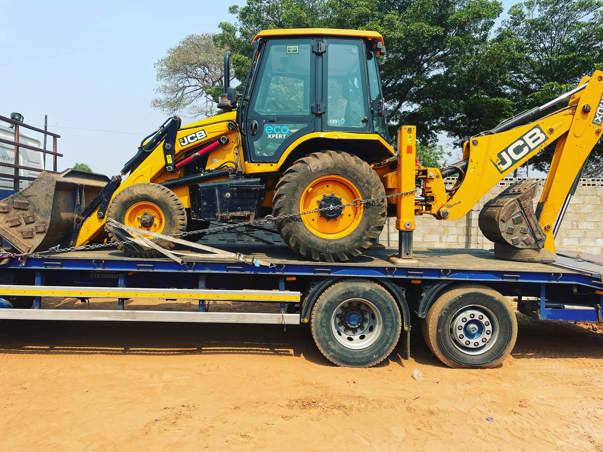 BMR backhoe loader on a transport truck