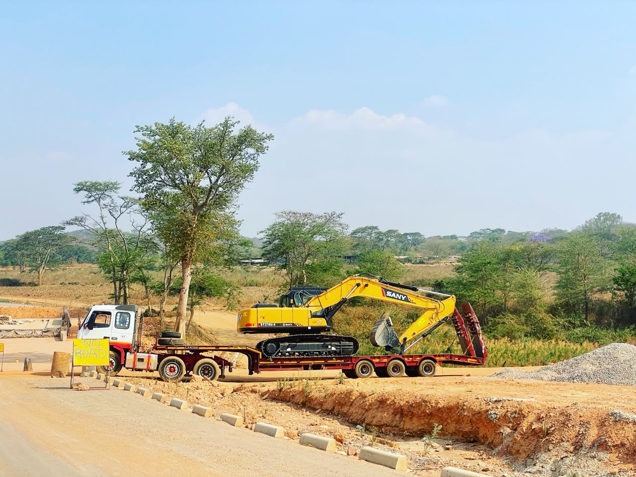 BMR excavator being transported on a low bed truck